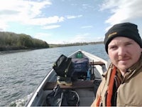 a man in a canoe on a lake